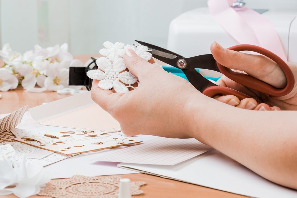 Person cutting flower designs