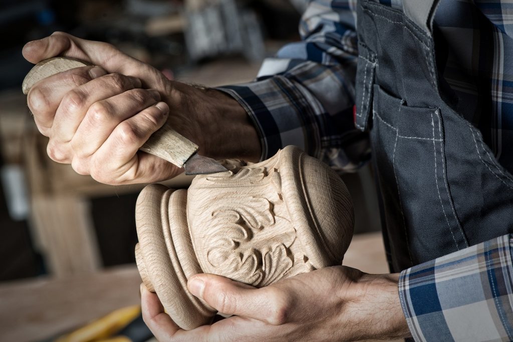 Man engraving designs on wood